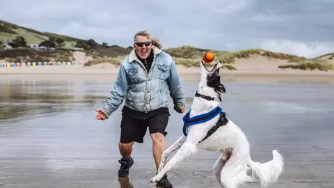 Vader with Mark on the beach playing ball